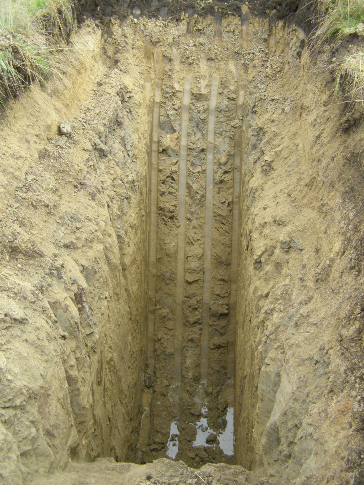 Soil profile investigation for the feasibility of a clay-lined water reservoir.